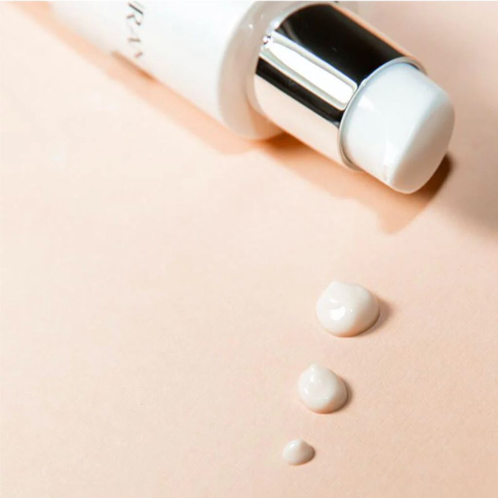 Rejuran Advanced Intensive Corrector cream with pump bottle on a beige background