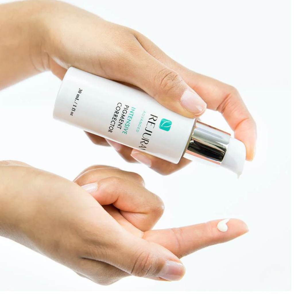 Hand holding Rejuran Intensive Pigment Corrector on a white background